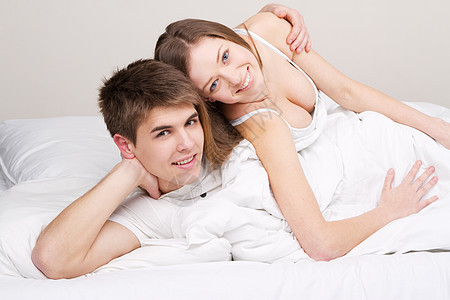 床上的一对漂亮的夫妻男性婚姻卧室性别幸福丈夫就寝异性女孩唤醒图片