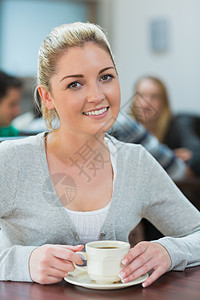 坐在大咖啡厅里喝咖啡的女学生图片