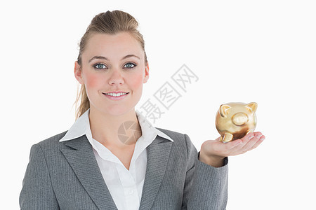 拥有小猪银行的女商务人士套装女士人士浅色储蓄商务管理人员存钱罐头发金子图片