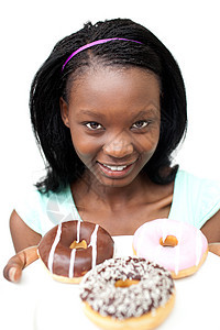 看甜甜圈的年轻迷人女人图片
