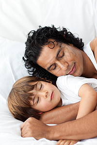 小男孩和他父亲一起睡在一起了图片