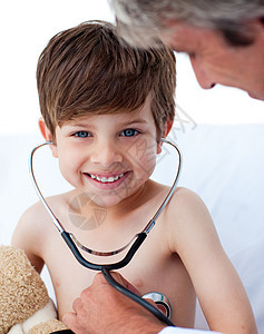 与一个小男孩玩耍的看管医生儿科保健医师病人微笑男生诊所办公室男性康复图片