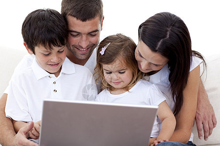 家中使用笔记本电脑的年轻家庭图片