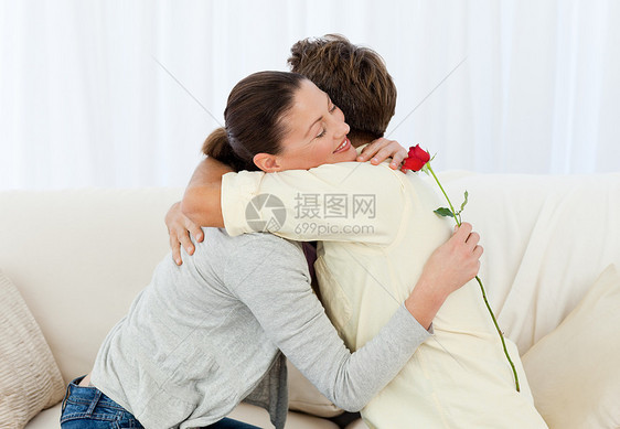 可爱的女子在接了花后拥抱他的男朋友图片