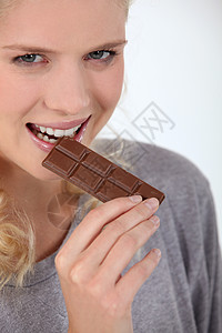 女人吃巧克力微笑食物淑女甜点休息商品化牙齿妻子蓝绿色眼睛图片