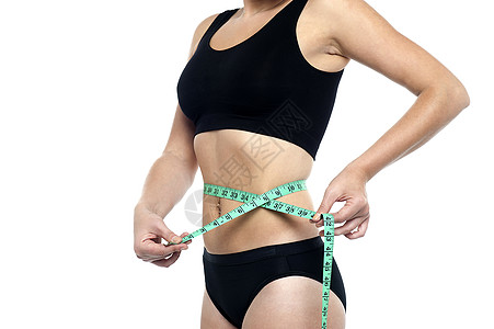 测量腰部 作物形象的合适妇女图片