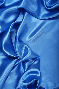 平滑优雅的蓝色丝绸作为背景海浪银色折痕材料天蓝色纺织品投标曲线布料织物图片