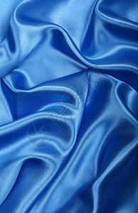 平滑优雅的蓝色丝绸作为背景布料银色曲线折痕海浪天蓝色纺织品材料投标织物图片