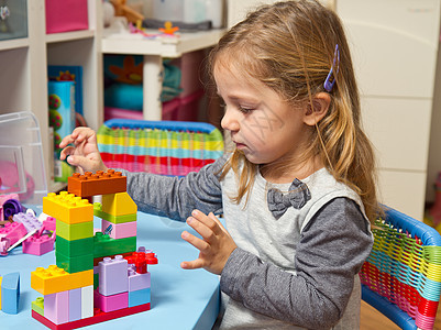 小女孩在玩砖头的木砖青年玩具教育学习水平幼儿园育儿女性建筑童年图片