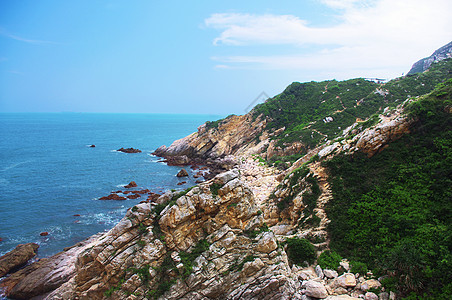 中国的海边有巨大的岩石土地悬崖青色海水海浪海湾风景青金石日落海岸图片