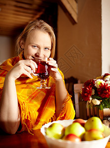 年轻女人在喝茶和微笑图片