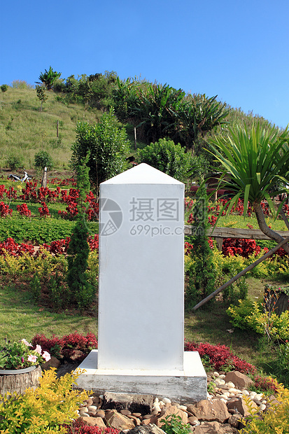 具有山地和蓝天空背景的道路上的里程碑树木边缘花岗岩天空地标旅行小路农村英语蓝色图片