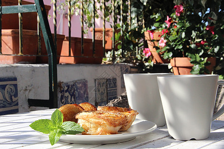 葡萄牙风格的美味蛋糕小吃奶油早餐薄荷盘子饮食作品花朵饼干杯子图片