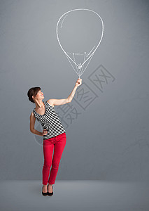 美貌的女士拿着气球画女性玩具微笑闲暇笑脸庆典幸福乐趣女孩演讲图片