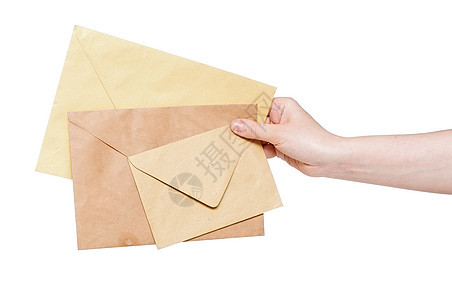 手上的黄色信封在白色背景上被孤立卡片邮件办公室文档邀请函笔记问候语图片