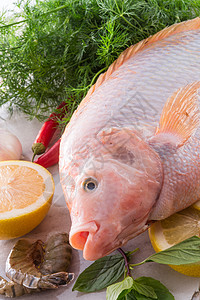 尼罗河蒂拉皮亚鱼眼睛食物盘子饮食宏观贝类螃蟹工具美食营养图片
