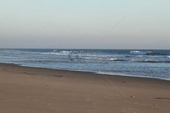 沙滩日落奥尔蒙海滩旅行热带海岸天气蓝色辉光地平线海浪阳光海洋图片