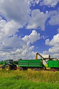 组合收割器工作拖拉机农村粮食燕麦农业太阳收成场地农民图片