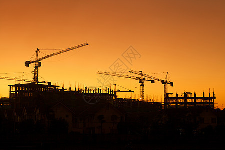 建筑工地脚手架住宅建筑工人项目活动日落起重机工程结构框架图片