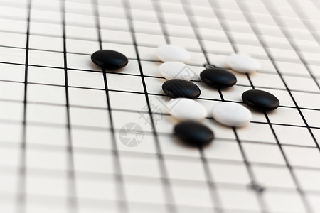 传统的中国棋盘游戏  Go挑战生活死亡乐趣古董战略闲暇木板木头桌子图片