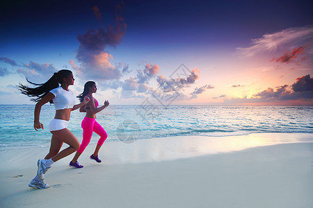 两个女人在沙滩上奔跑成人跑步慢跑海滩训练运动员赛跑者运动装运动天空图片