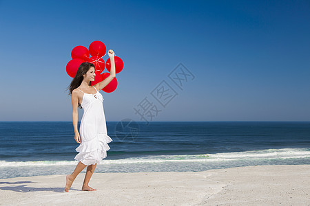 带着红色芭蕾舞的漂亮女孩海洋成人闲暇微笑青年气球幸福女孩自由假期图片