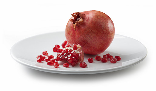 盘子中石榴籽石榴白色水果盘子红色甜点种子背景