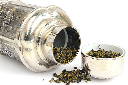 茶壶白色金属文化绿色叶子球座绿茶茶叶黑色银器图片