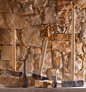 石匠泥瓦工的锤子工具建筑岛屿石工装饰石头建造栅栏房子石墙风格图片