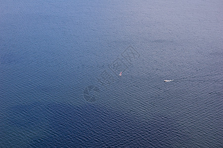 小型小船阳光照射日落海浪图片