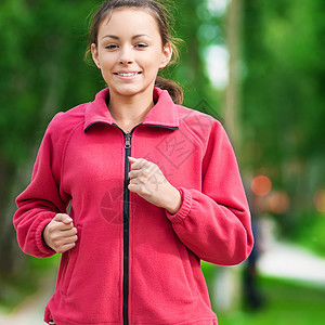 少女在绿色公园中奔跑头发跑步精力运动员环境运动女士公园专注叶子图片