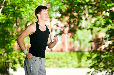 年轻人在公园里慢跑行动活动运动员男性自由跑步闲暇慢跑者运动装森林图片