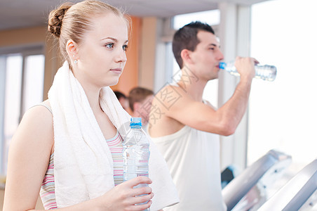 在体育馆运动后饮用饮用水的男女健身房跑步跑步机夫妻福利活力闲暇女性团体娱乐图片