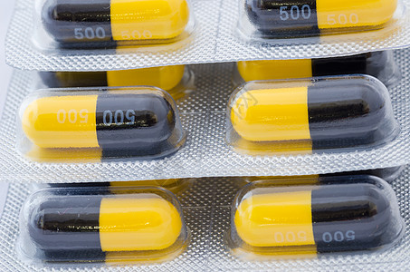 黑色和黄色胶囊疾病制药药品药店团体宏观剂量图片