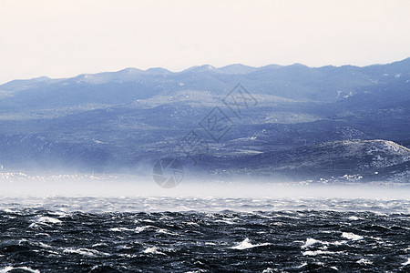 狂浪笼罩着大海海浪危险阳光蓝色愤怒爬坡雷雨天气戏剧性风暴图片