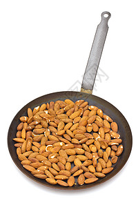 白色背景的烤杏仁煎饼饮食坚果厨房金属植物群烹饪种子活力用具营养图片