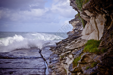 在悬崖脚下破碎的波浪背景图片