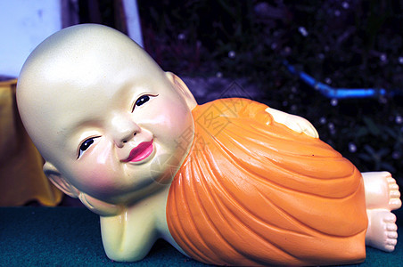 可爱的小和尚冥想纪念品寺庙娃娃橙子玩具微笑说谎黄色乐趣图片