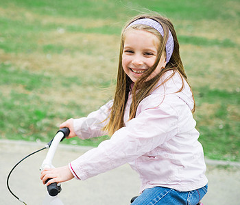 带着自行车的小女孩娱乐头盔绿色幼儿园青年女孩运动快乐骑术乐趣图片