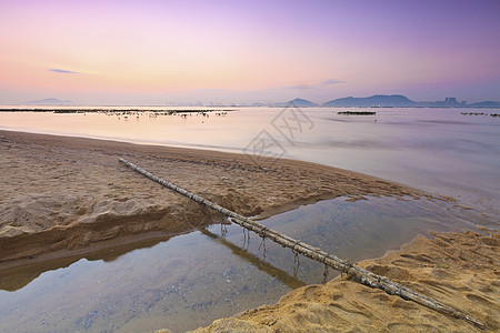 沿海日落地平线海滩太阳反射假期海浪海洋蓝色石头海岸图片