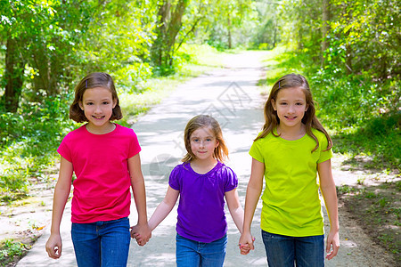 朋友和姐妹姊妹女孩在森林轨道露户外散步旅行假期双胞胎团体朋友们童年派对丛林树木幸福图片