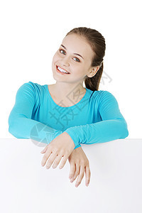 带着空白纸板的年轻快乐少女肖像营销商业管理人员女孩广告牌横幅成人海报展示木板图片