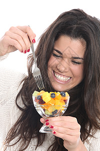 女青年食用新鲜水果沙拉鲜果沙拉头发面孔白色吸引力女士图片