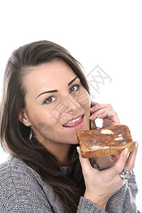 妇女食用棕色吐司面包白色早餐女士头发图片
