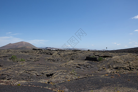 兰萨罗特的某个地方阳光爬坡海滩岩石目的地旅行荒野骨灰天空时间图片