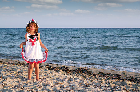 沙滩夏日风景中美丽的小女孩图片