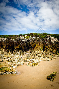 岩石海滩太阳支撑天空海浪地平线蓝色沿海阳光旅游场景图片