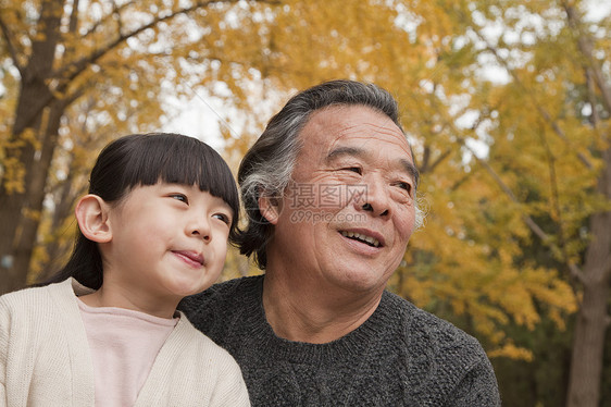 爷爷和孙女在公园里保暖毛衣俏皮喜悦童年两个人团结快乐微笑休闲图片