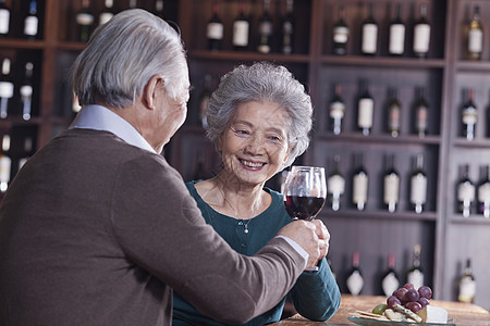 饮酒 以女性为焦点的 老夫妇共餐和享受自己喝饮料 关注女性服装幸福头发瓶子老年休闲微笑团结品酒水果图片