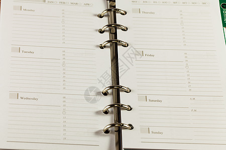 黑色笔记簿组织者对白色背法的特写图像笔记本条目议程文学商业日程规划师床单笔记数字图片